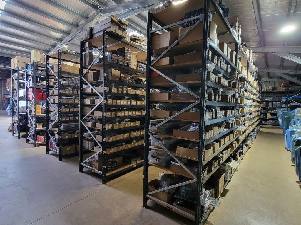 Racking stocked with tractor and earthmoving parts inside the South Burnett Tractor Parts warehouse